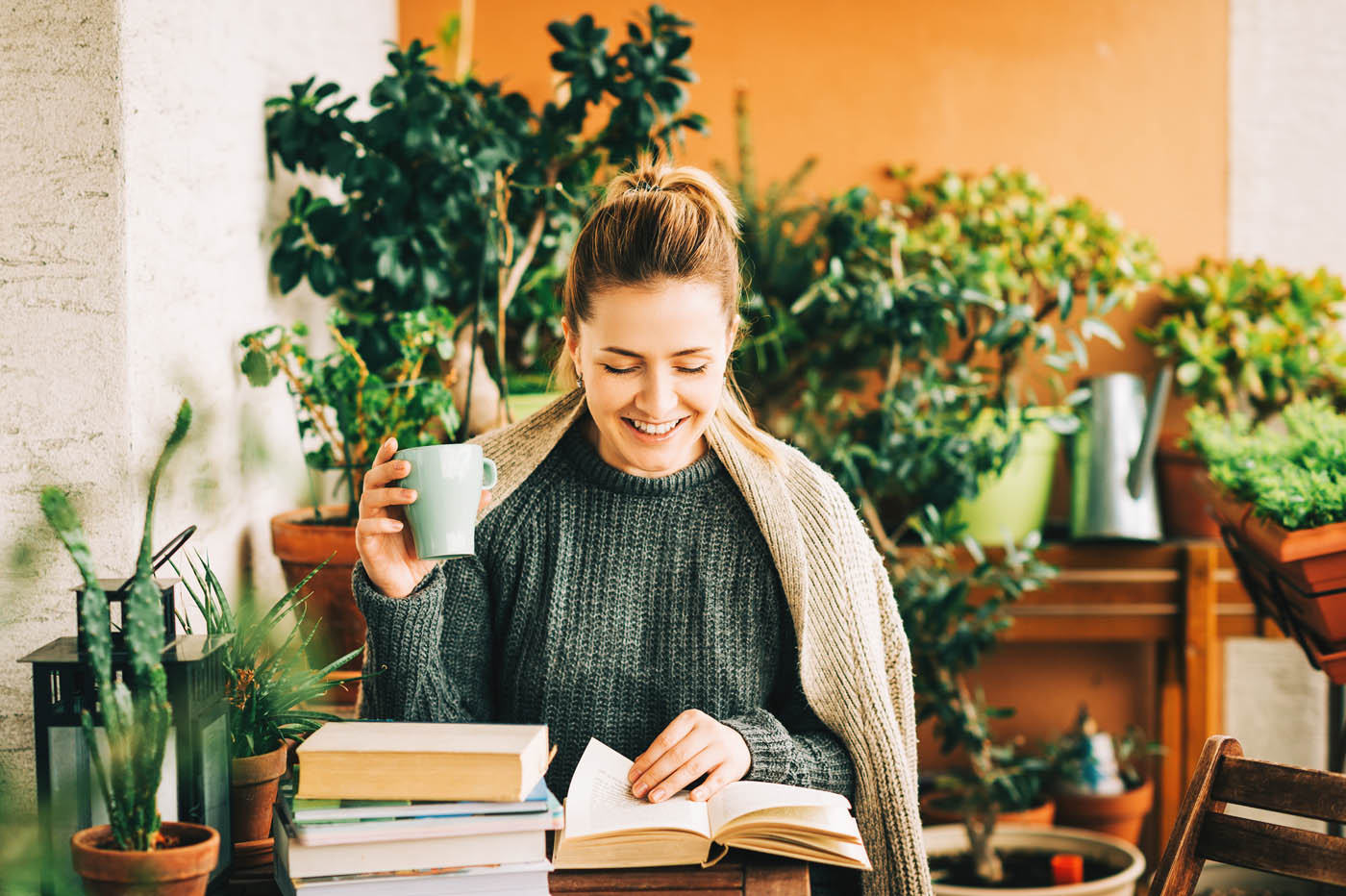 An image of a woman enjoying her space and reading a book - learn how Hello Pest keeps your property safe and protected with expert pest management in Westchester County, NY.